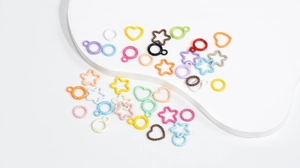 Close-up of colorful heart and star alloy pendants for DIY jewelry making accessories