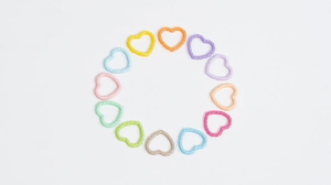 Macro detail of colorful macaron heart-shaped DIY resin jewelry accessories in 12 colors