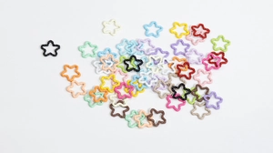 Macro detail of colorful star-shaped textured jewelry connectors for DIY crafts