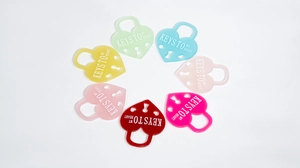 Colorful heart-shaped acrylic charms with Keys To My Heart text and clover-style cutouts