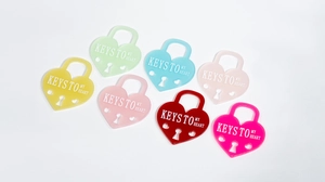 Macro shot of colorful acrylic heart-shaped locks with Keys To My Heart text print