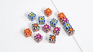 Macro shot of colorful checkered cube beads with sunflower patterns for DIY jewelry making