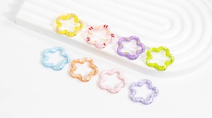 Macro shot of colorful flower-shaped alloy spring gate rings for DIY keychains