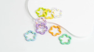 Close-up of pastel macaron flower-shaped alloy spring rings for DIY keychains
