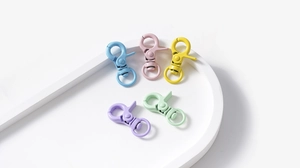 Close-up of five colorful matte alloy lobster clasps for DIY keychain making in pastel tones
