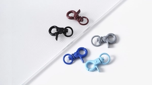 Close-up of colorful metal lobster clasps with 360-degree swivel rings on white background
