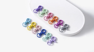 Close-up of colorful matte metal lobster clasps for DIY jewelry making on white display