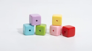 Close-up of colorful acrylic square beads with center holes for DIY jewelry making