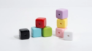 Close-up of colorful square acrylic beads with center holes for DIY jewelry making