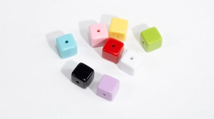 Close-up of colorful acrylic square beads with vertical holes for DIY jewelry making