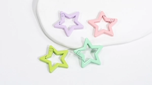 Detail of star-shaped carabiners in macaron colors with spring gate for DIY keychains
