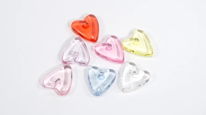 Macro shot of colorful transparent heart-shaped acrylic resin beads for DIY jewelry making