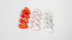 Flat lay of colorful heart-shaped acrylic resin beads for DIY jewelry making