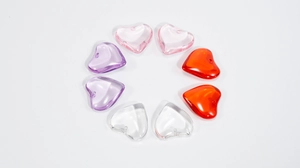 Macro shot of colorful acrylic heart beads for DIY jewelry making in various transparent shades