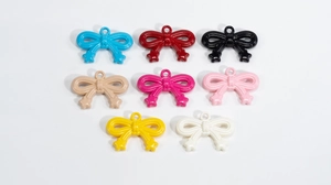 Close-up of colorful acrylic bow star charms for DIY keychain and phone accessory making