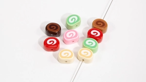Macro shot of colorful spiral swiss roll beads for DIY jewelry and keychain making