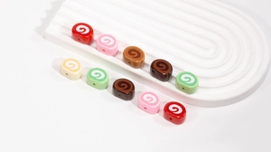 Detailed view of colorful spiral swiss roll resin beads for DIY jewelry making