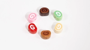 Close-up of colorful spiral swiss roll beads for DIY jewelry and keychain making