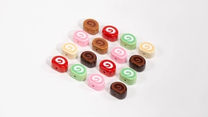 Macro shot of colorful Swiss roll shaped wooden beads for DIY jewelry and crafts making