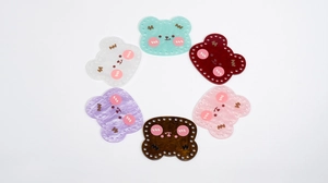 Detailed view of colorful acrylic bear charms with pre-drilled holes for DIY bag making