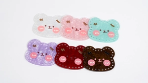 Detail view of colorful acrylic bear-shaped DIY base plates with pre-punched holes