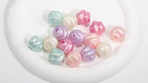 Macro detail of spiral textured acrylic macaron beads with glossy pearl finish for DIY