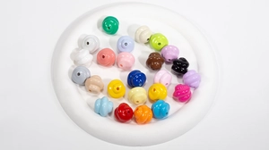 Colorful resin spiral beads set for DIY jewelry crafts in a white decorative tray