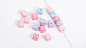 Detail of colorful acrylic letter beads with motivational words for DIY phone chains