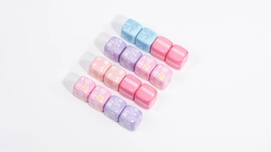 Macro shot of colorful acrylic word beads in blue, pink, and purple for DIY craft projects