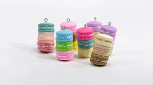 Macro detail of colorful macaron resin charms with metal screw eyes for DIY keychain making