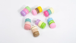 Macro detail of colorful macaron charms with metal loops for DIY jewelry making