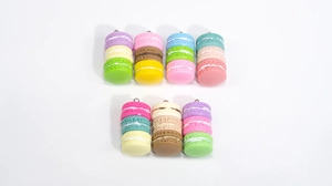 Detailed view of colorful 3-layer acrylic macaron charms with metallic top rings