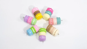Detail view of colorful triple-stacked resin macaron pendants for DIY jewelry crafting