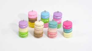 Close-up of colorful macaron sandwich charms with silver eyelet pins for DIY jewelry
