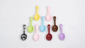Detail of colorful mini spoon charms in various pastel shades for DIY jewelry making