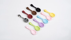 Close-up of 10 colorful mini metal spoons with polished finish for DIY jewelry making