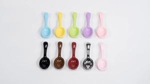 Flat lay of colorful mini spoon charms with vibrant metallic finish for DIY crafts