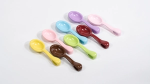 Detailed view of eight colorful mini plastic spoons for DIY pendant crafts