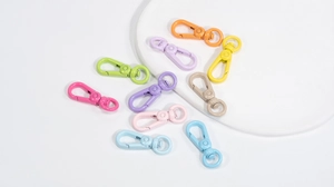 Close-up of colorful round spring buckles and snap hooks for DIY keychain accessories
