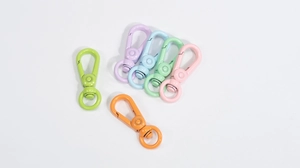 Close-up of colorful round carabiner spring rings in six vibrant painted alloy finishes