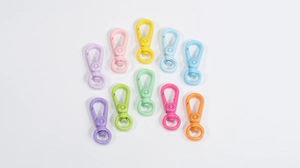 Close-up of 10 colorful macaron round carabiners and spring hooks for DIY keychains