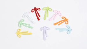 Colorful alloy bow pendants in various shades for DIY jewelry making and crafting