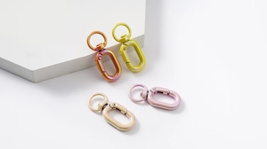 Macro shot of colorful gradient metal spring buckles in various iridescent hardware finishes