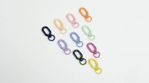 Close-up of ten colorful metal swivel lobster clasps for DIY jewelry and keychains