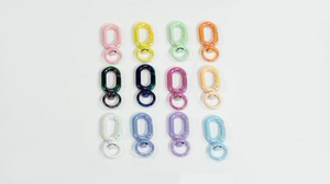 Flat lay of colorful 12-piece swivel spring snap hooks for DIY keychains and accessories