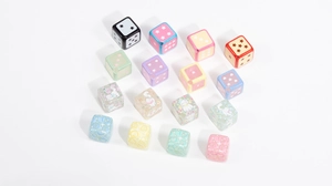 Close-up of colorful acrylic cube beads with star, heart and cartoon cat patterns