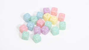 Macro shot of macaron colored acrylic cube beads with heart and star patterns for DIY jewelry
