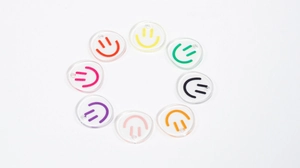 Close-up of colorful acrylic smiley face charms for DIY keychains and jewelry making