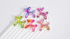 Macro detail of laser iridescent acrylic balloon dog charms for DIY jewelry making