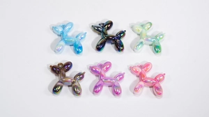 Detailed view of six colorful acrylic balloon dog charms with glossy metallic finish